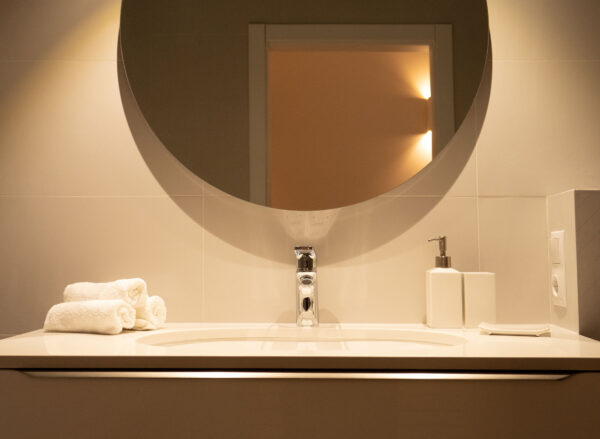 bright bathroom with round mirror