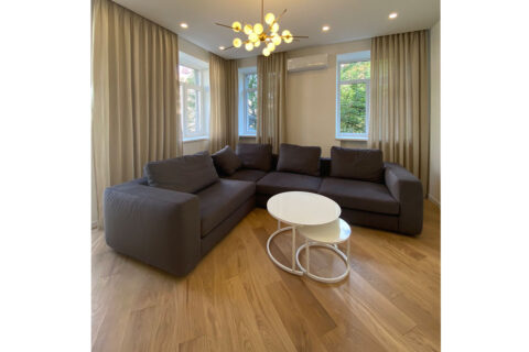 spacious living room with grey sofa