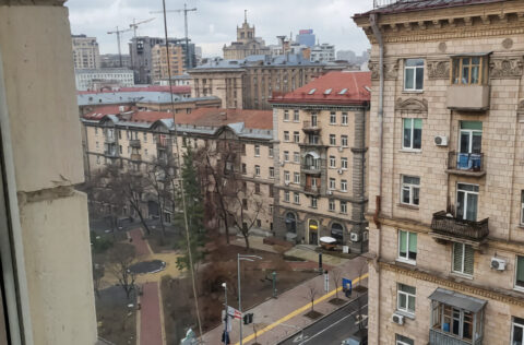 City view from window overlooking Kyiv street and historic buildings