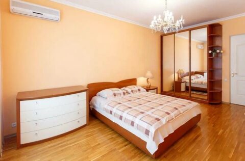 Spacious bedroom with double bed, wardrobe and air conditioner