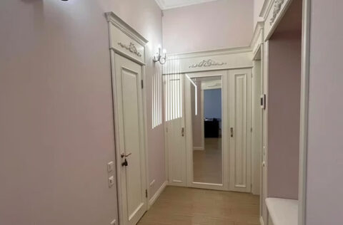 Elegant corridor with wooden doors and parquet in Kyiv apartment for sale in Kyiv, Sichovykh Striltsiv 10 historic centre