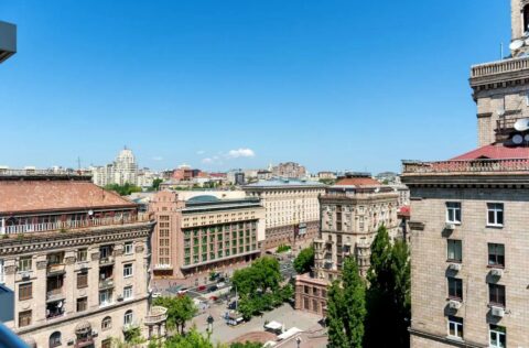 Panoramic window view from apartment for sale in Kyiv, Khreshchatyk 27-B, Pecherskyi district, overlooking Bessarabka and central Kyiv city lights.