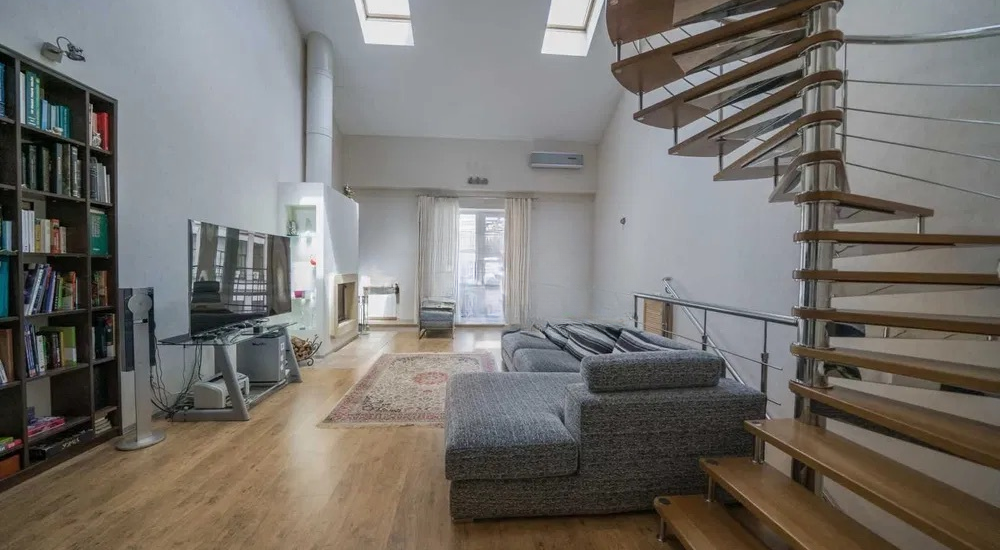 living room with staircase apartment for sale in Kyiv Rylskyi Lane 3 Shevchenkivskyi district penthouse 9m ceilings fireplace