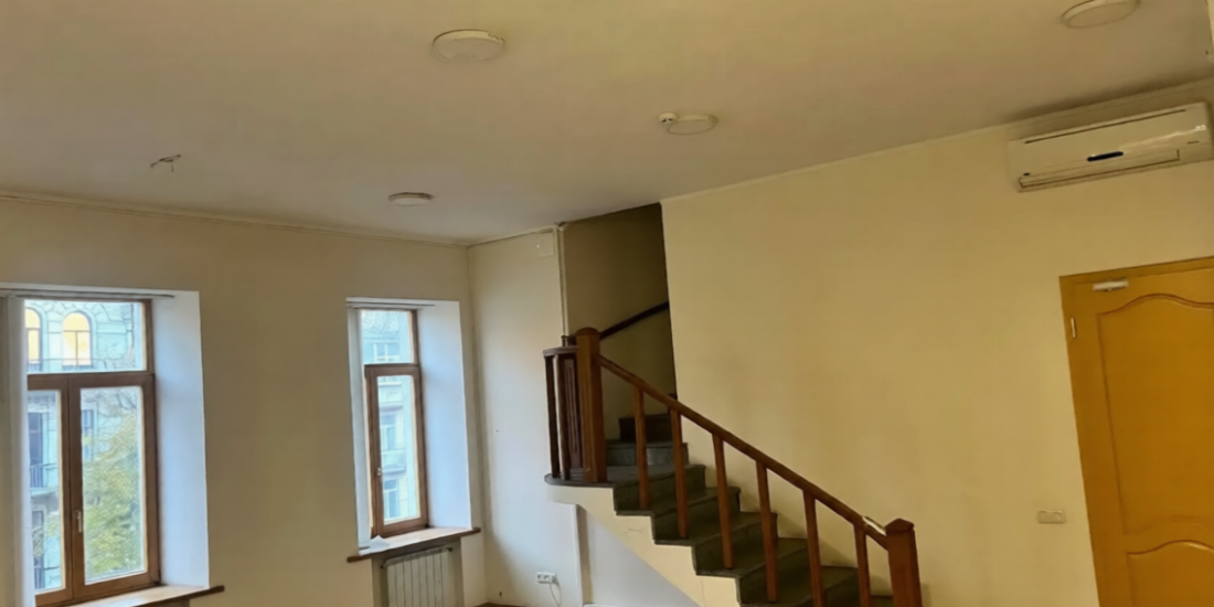 Stairs to the second level in a historic apartment on Volodymyrska Street, Kyiv