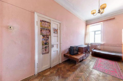 Bedroom in a pre-revolutionary apartment on Yevhena Chykalenka Street 25, Kyiv, requiring renovation