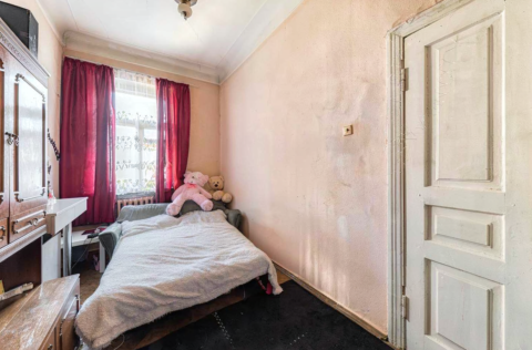 Bedroom in a pre-revolutionary apartment on Yevhena Chykalenka Street 25, Kyiv, requiring renovation