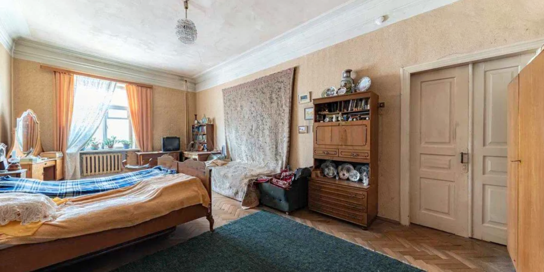 Bedroom in a pre-revolutionary apartment on Yevhena Chykalenka Street 25, Kyiv, requiring renovation