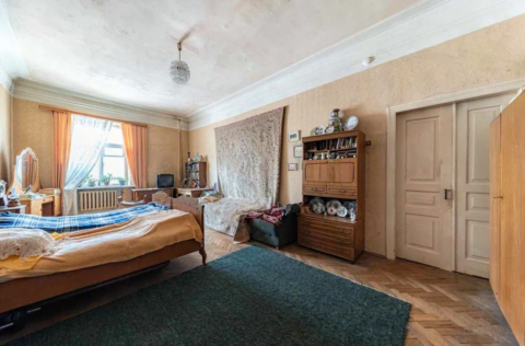 Bedroom in a pre-revolutionary apartment on Yevhena Chykalenka Street 25, Kyiv, requiring renovation