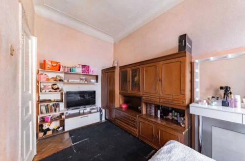 Bedroom in a pre-revolutionary apartment on Yevhena Chykalenka Street 25, Kyiv, requiring renovation